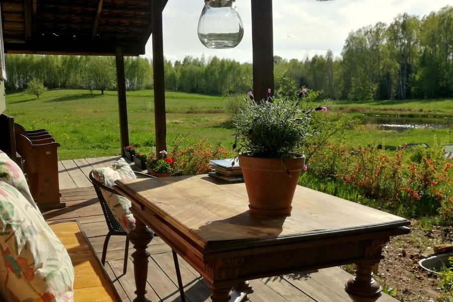 Summer kitchen terrace with view on meadow and forest